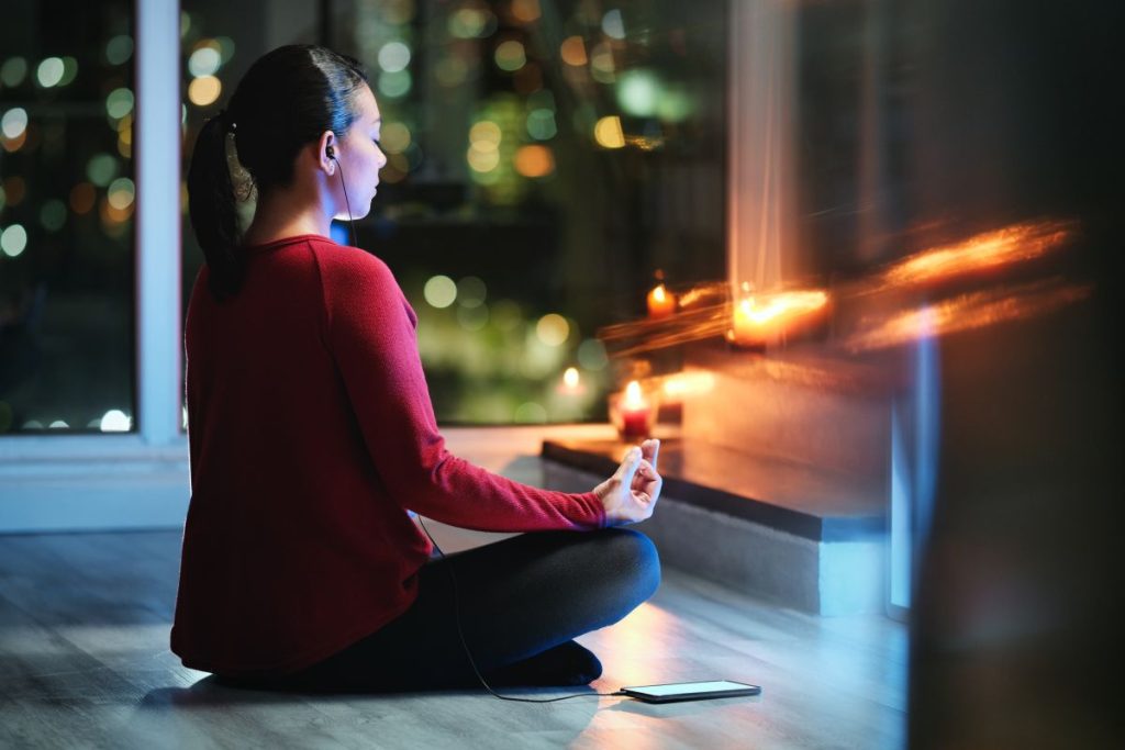 woman doing night meditation for better sleep